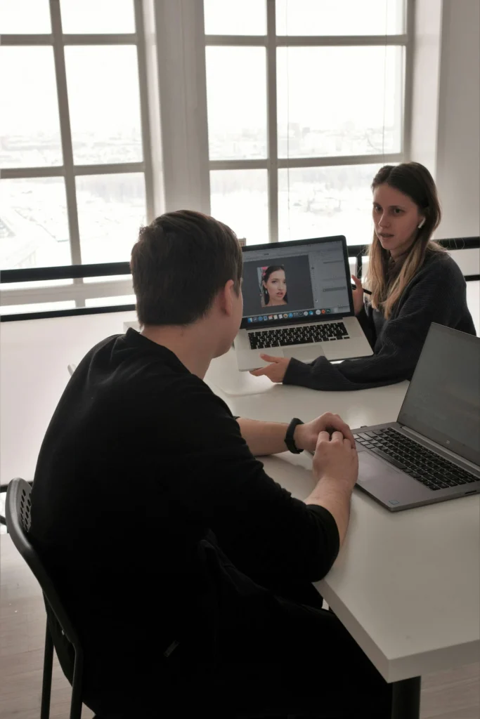Marketing specialists at MetaBaz in Richmond Hill discussing portrait editing and visual content strategy for a local brand's social media campaign.