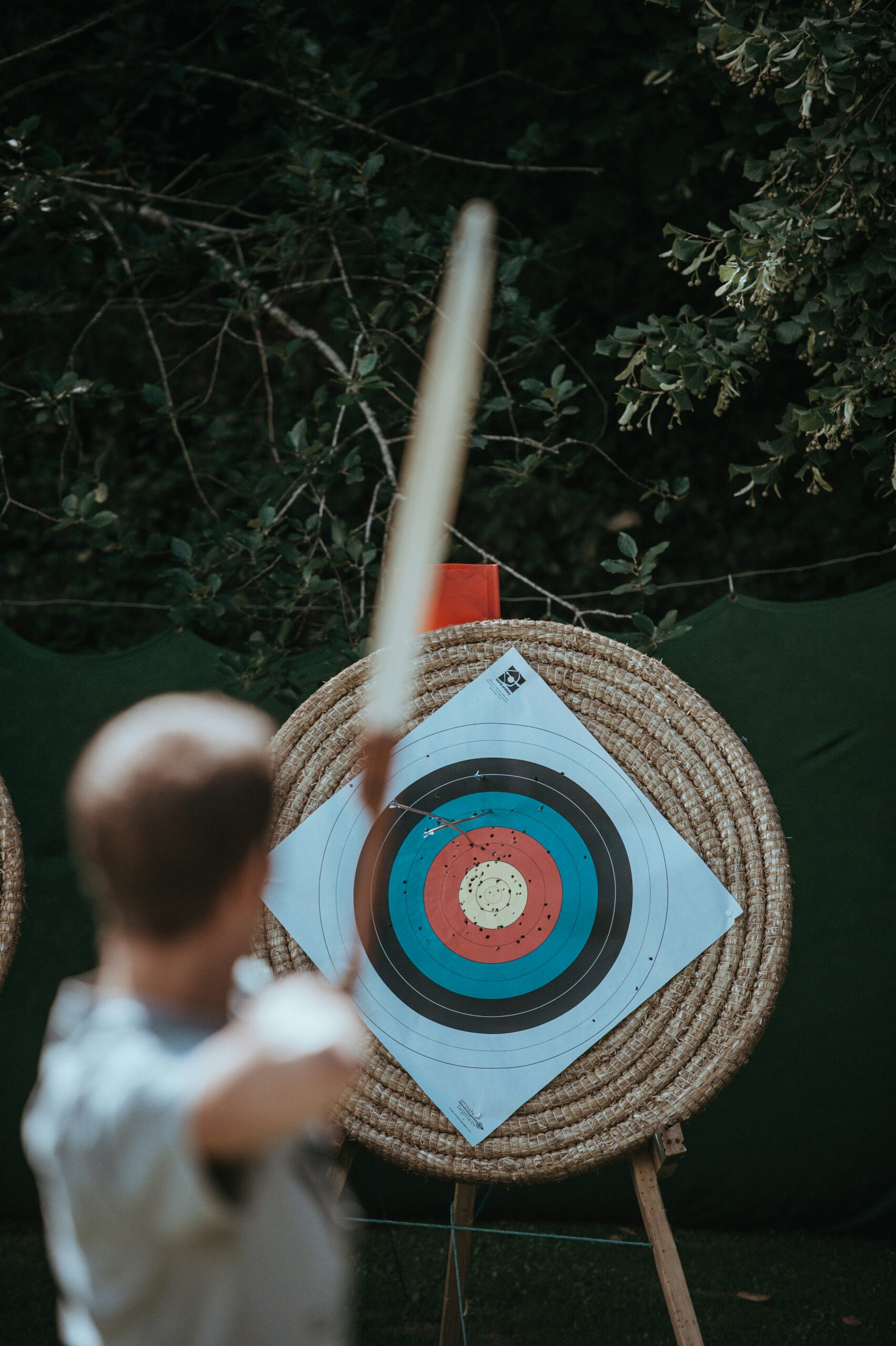 A person aiming at a target with an arrow, symbolizing precision retargeting and remarketing strategies designed to re-engage high-intent website visitors.